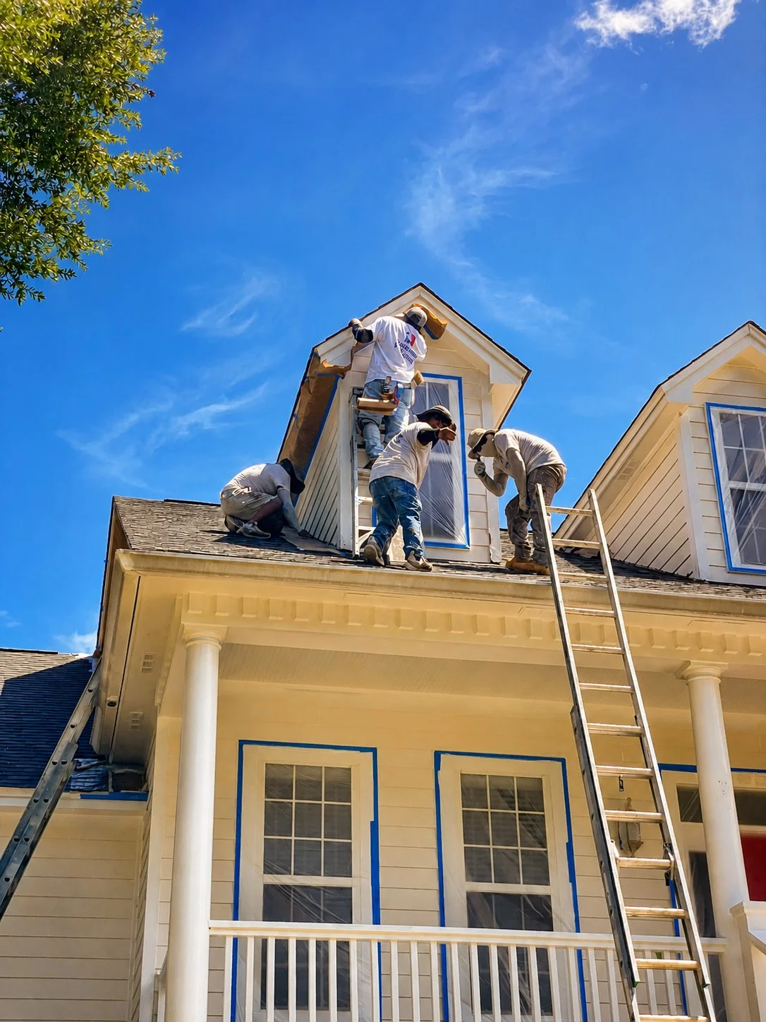 Seminole Ventures Painting crew preparing roofline and dormers for exterior paint