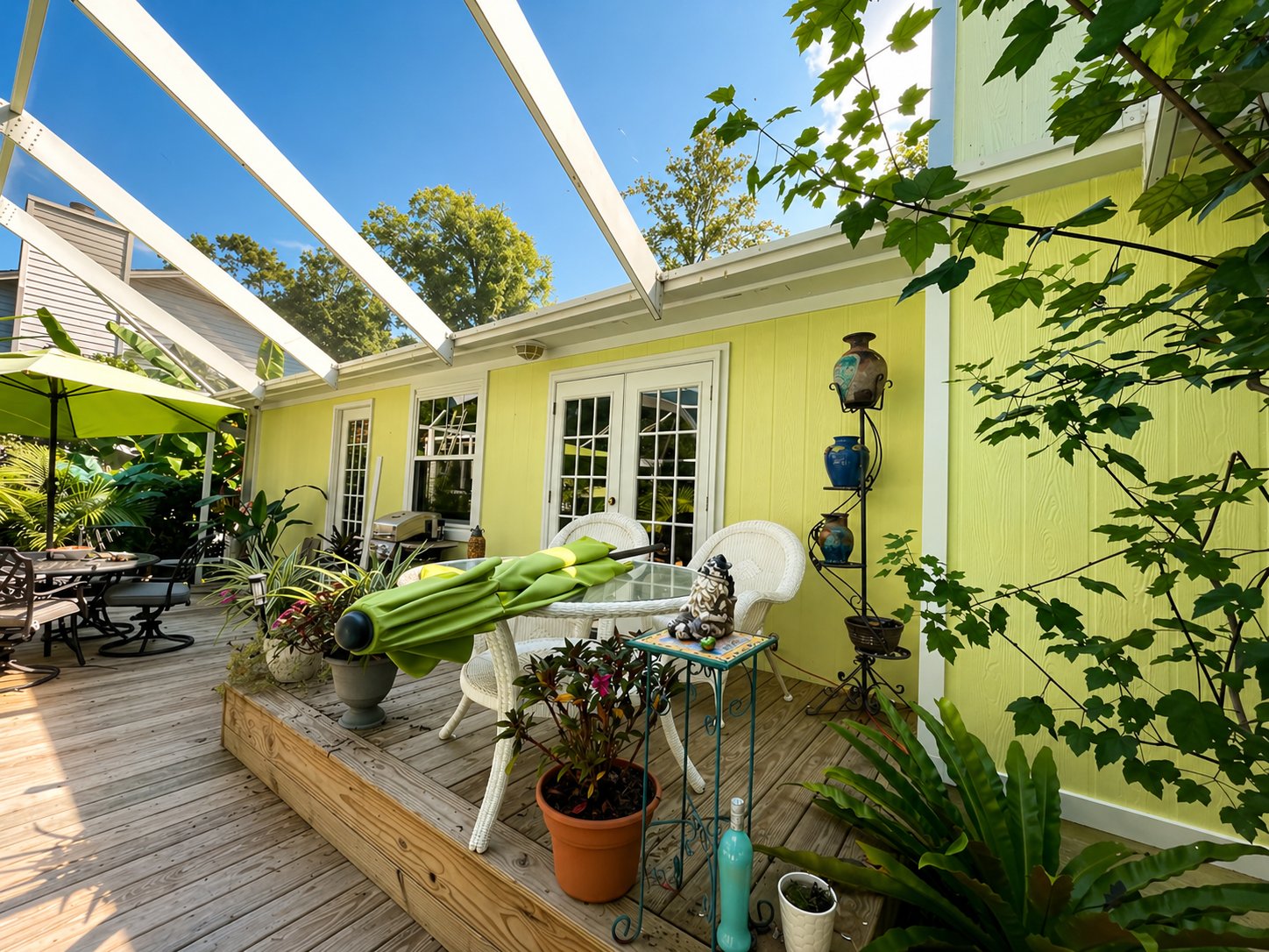 Exterior and deck painting — vibrant lime green siding with white pergola and outdoor living space by Seminole Ventures Painting