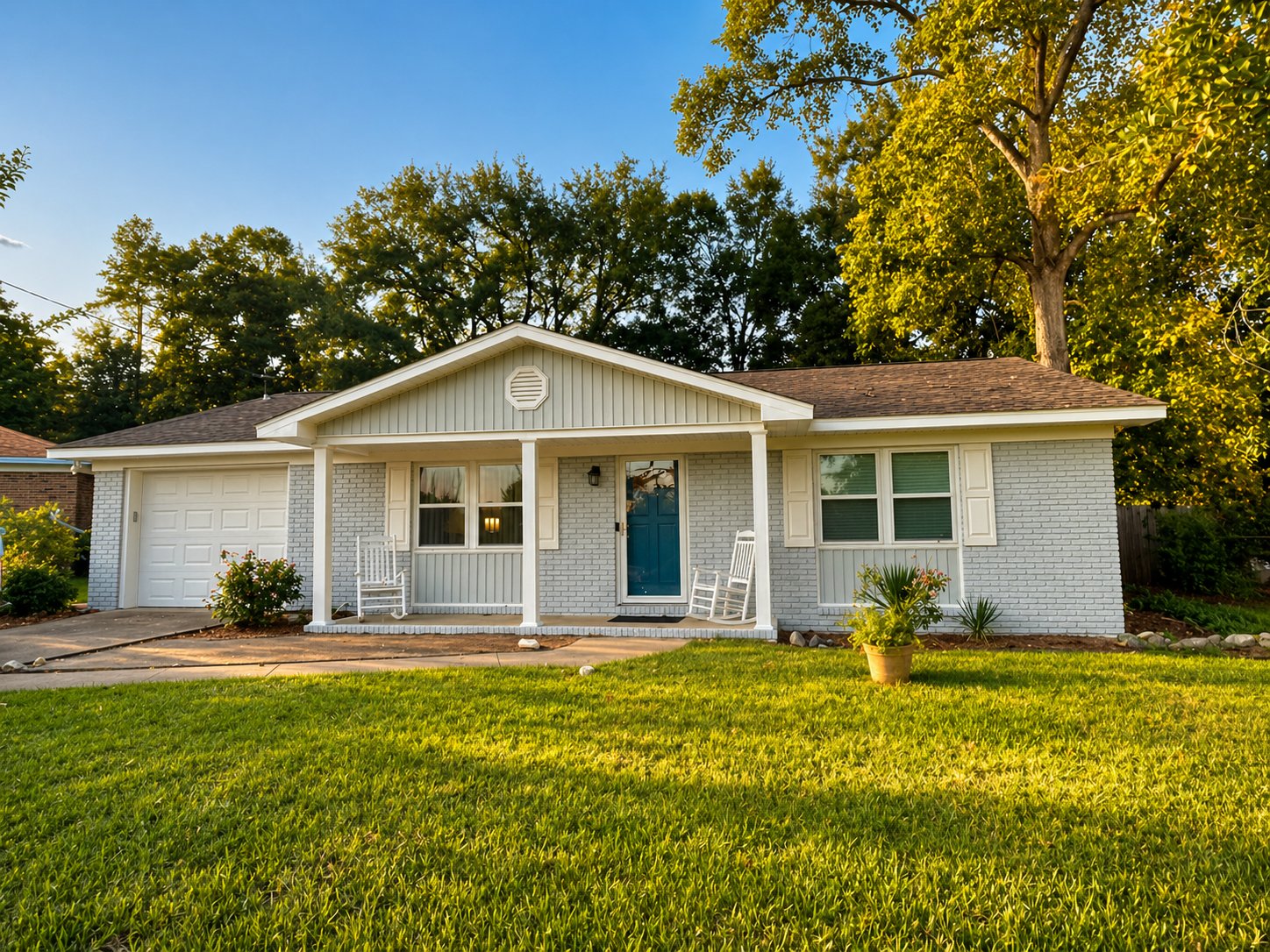 Brick exterior painting — gray painted brick ranch home with teal accent door by Seminole Ventures Painting in Tallahassee FL
